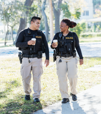 Two police officers walking and talking.