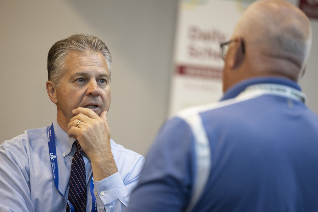 Executive Director Dave Unmacht has a serious conversation with a member at Annual Conference.