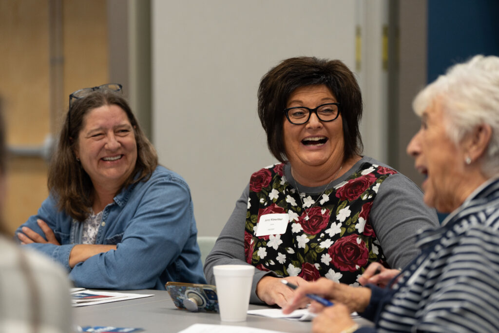 Three clerks laugh together during a session at the Clerks academy. 