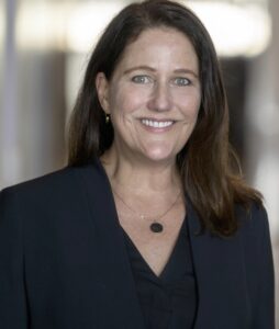 A professional headshot of Greater Minnesota Housing Fund CEO Andrea Brennan is shown.