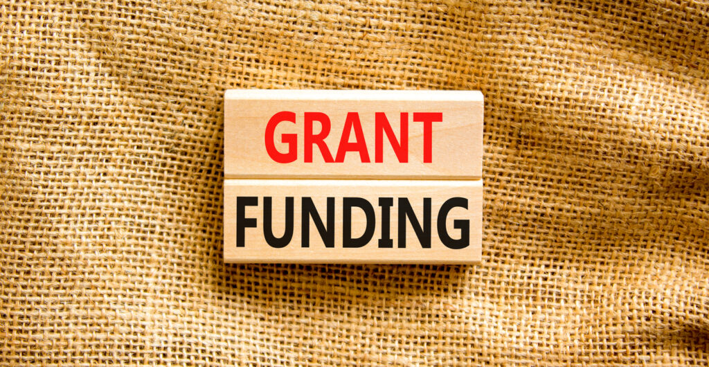 The words "grant funding" on wooden blocks.