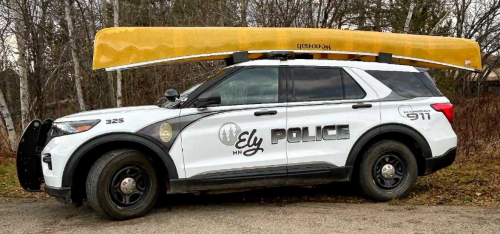 An Ely Police Department squad car is shown with a We-no-nah canoe on top of it.