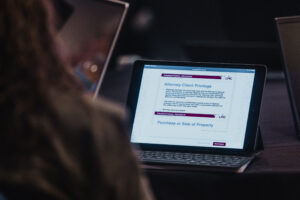 An Elected Leaders Institute participant's laptop is shown displaying learning material for elected officials