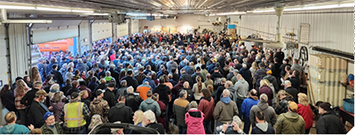 A large gathering of people at a public comment session.