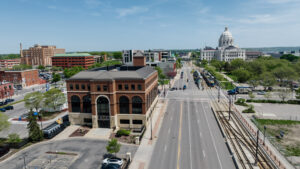 Aerial view of University Avenue, which shows the LMC building on the left and the Minnesota State Capitol grounds on the left.