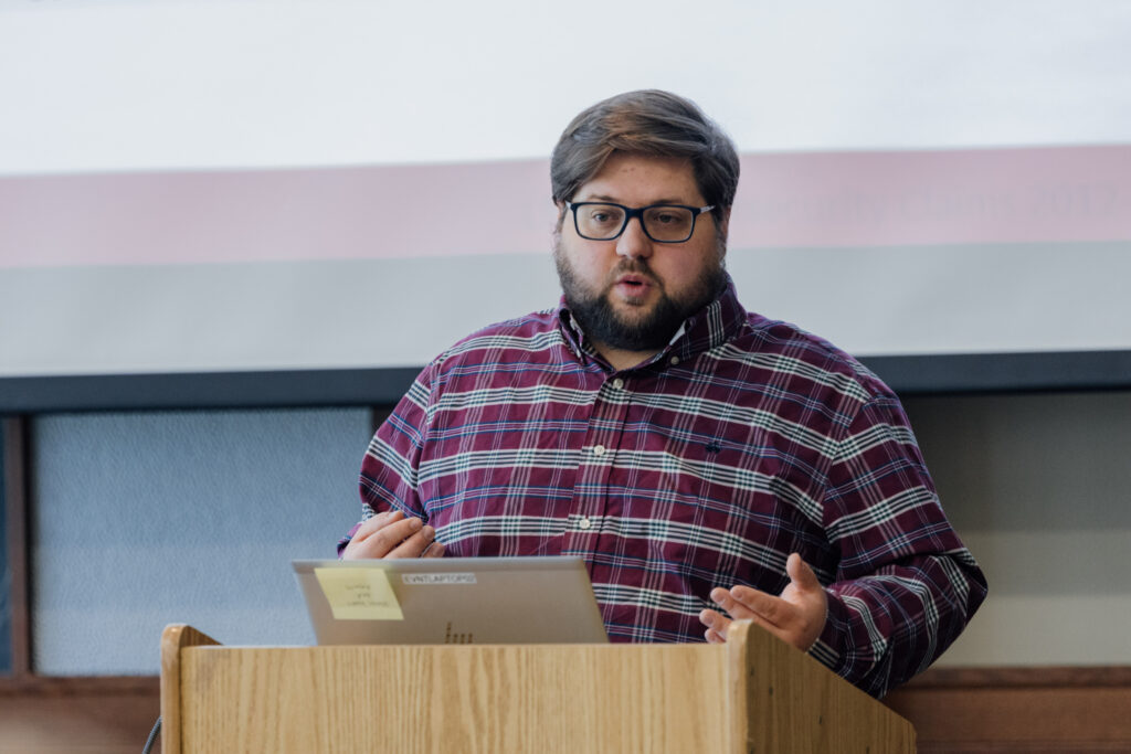 Christian Torkelson presents behind a podium at the 2024 Fall Loss Control workshops