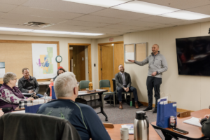 Luke Fischer and Daniel Lightfoot attend a meeting in Sandstone.