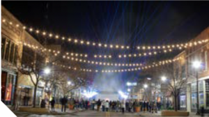 People gathered in downtown St. Cloud at night.