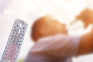 Man drinking water in extreme heat, Thermometer in summer day shows or indicate high temperature,