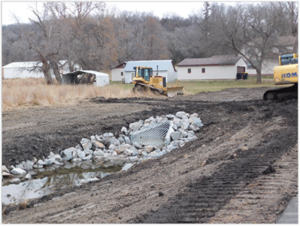 Excavating a flood drainage area.
