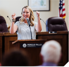 A person speaking at a meeting.