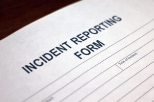 Someone filling out an Incident Reporting Form.