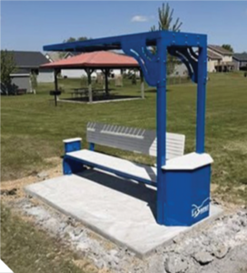 A blue bench in a park.